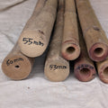 Solid bamboo poles with measurements marked on a textured surface